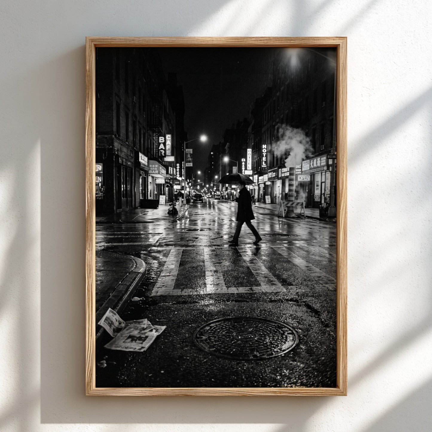 Black and white urban wall decor showing figure crossing wet street at night with reflective asphalt and