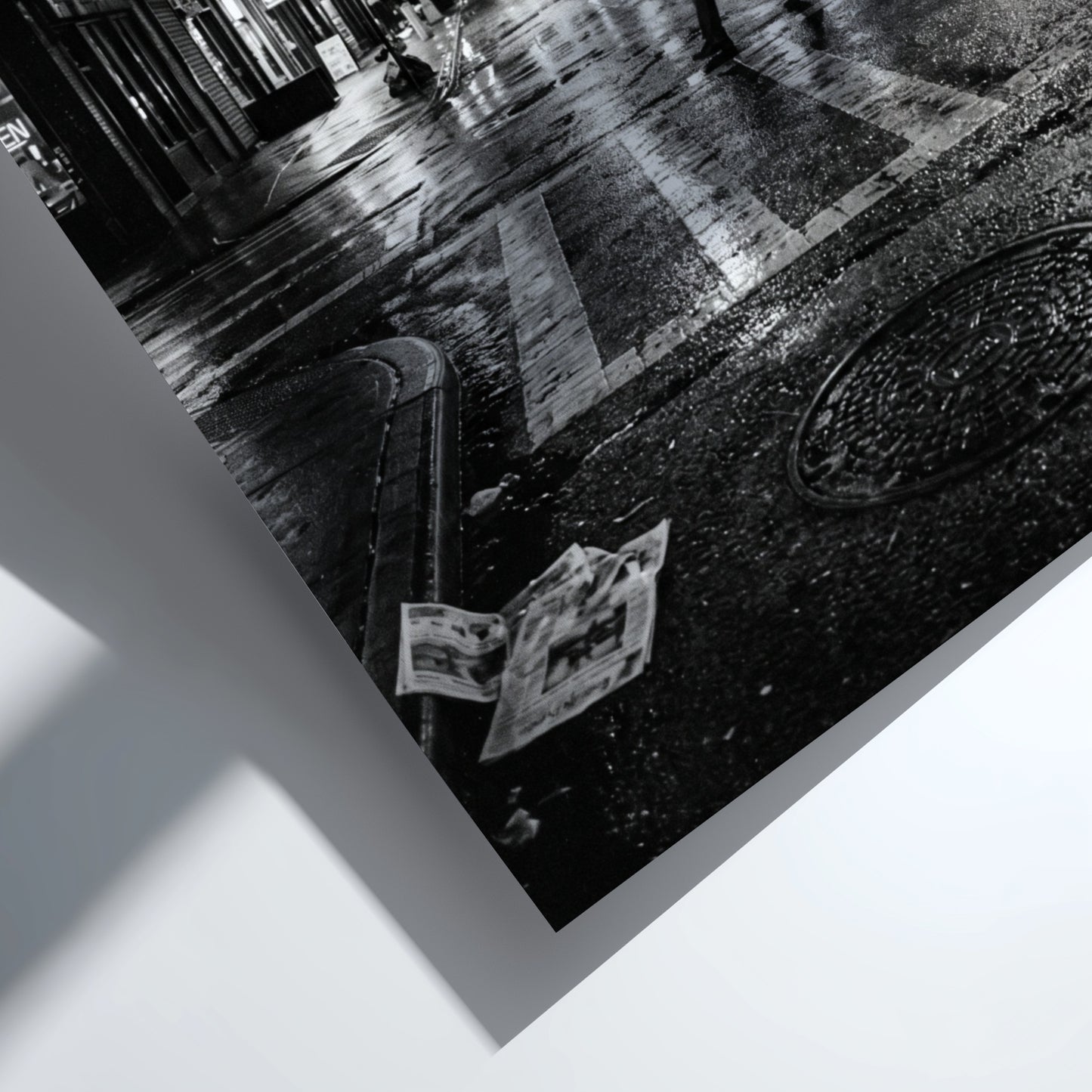 Black and white urban wall decor showing figure crossing wet street at night with reflective asphalt and