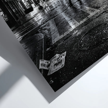Black and white urban wall decor showing figure crossing wet street at night with reflective asphalt and