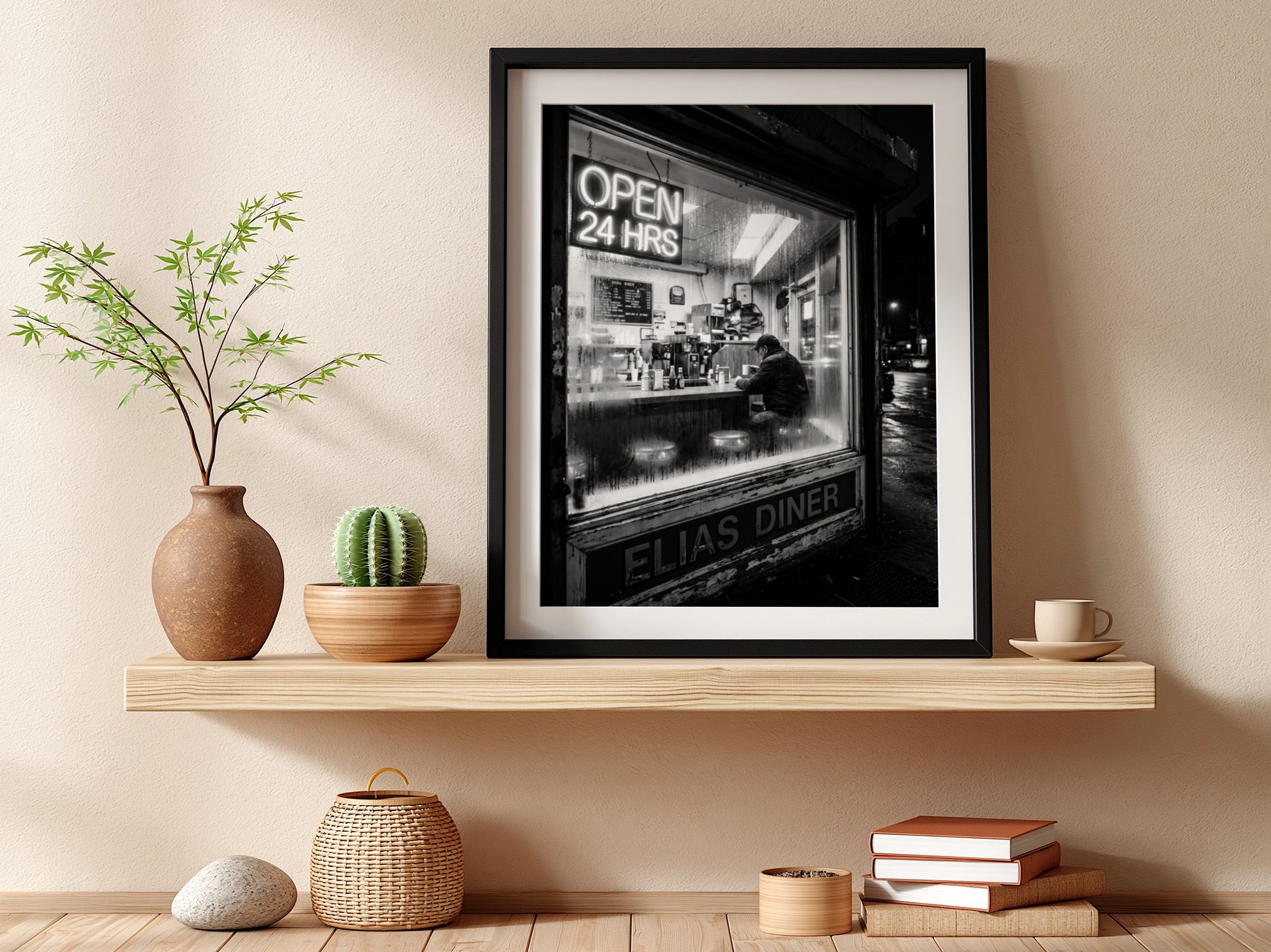 Poster of black and white diner interior with neon open 24 hrs sign and lone figure sitting