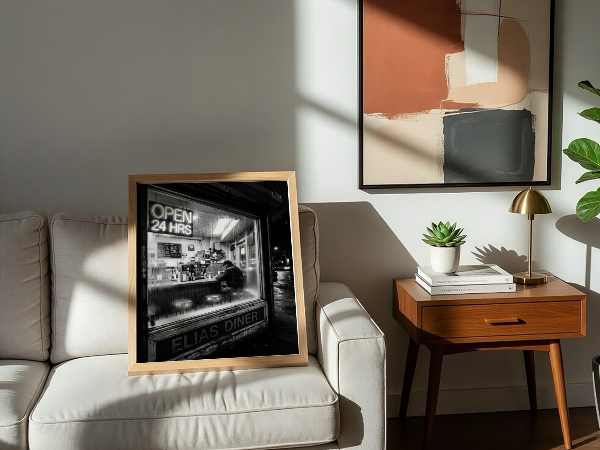 Poster of black and white diner interior with neon open 24 hrs sign and lone figure sitting