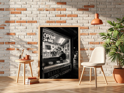 Poster of black and white diner interior with neon open 24 hrs sign and lone figure sitting