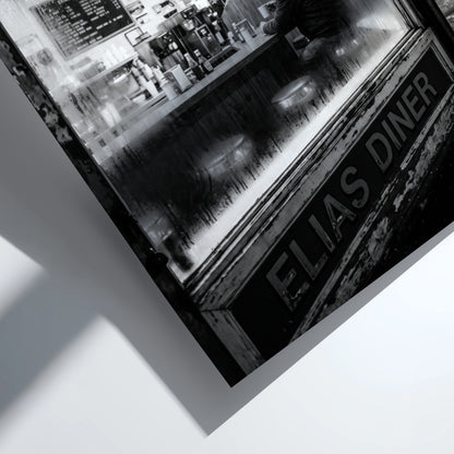 Poster of black and white diner interior with neon open 24 hrs sign and lone figure sitting