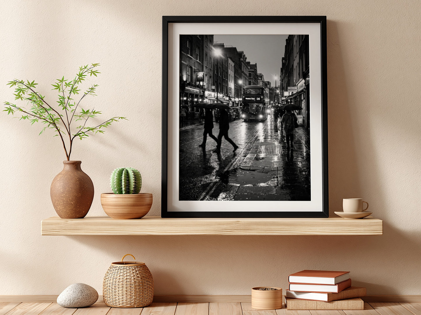 black and white wall decor showing figures walking on rainy city street with umbrellas and double-decker bus