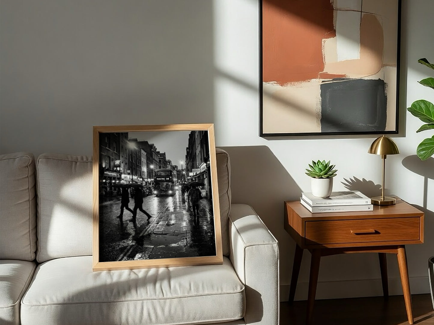 black and white wall decor showing figures walking on rainy city street with umbrellas and double-decker bus