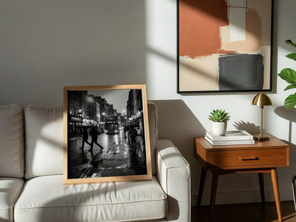 black and white wall decor showing figures walking on rainy city street with umbrellas and double-decker bus