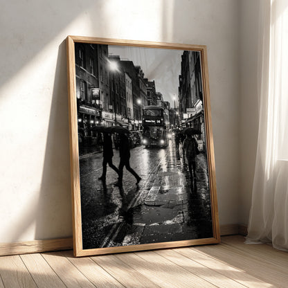 black and white wall decor showing figures walking on rainy city street with umbrellas and double-decker bus