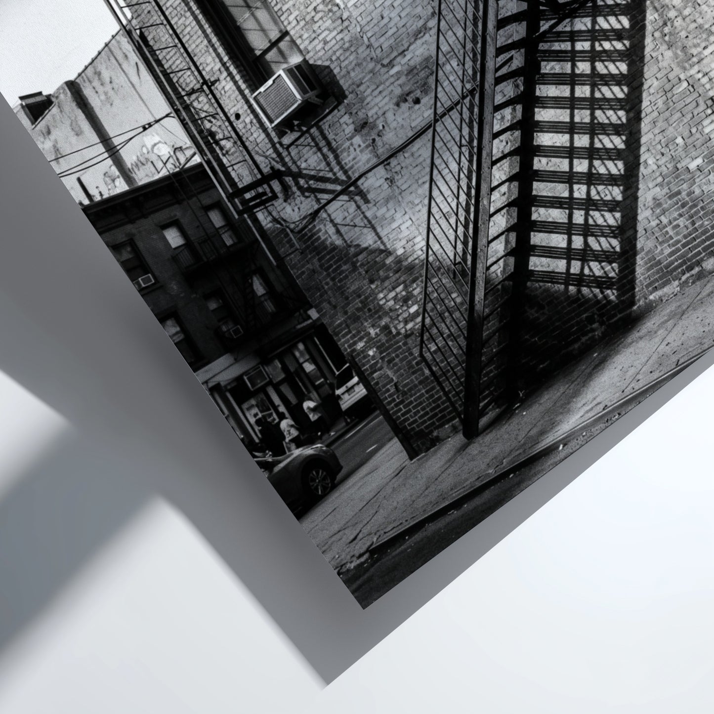 black and white wall decor showing fire escape on brick building with strong shadows