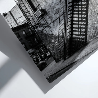 black and white wall decor showing fire escape on brick building with strong shadows