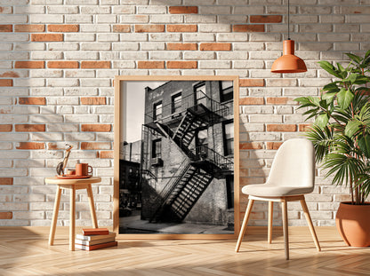 black and white wall decor showing fire escape stairs on brick building with shadows