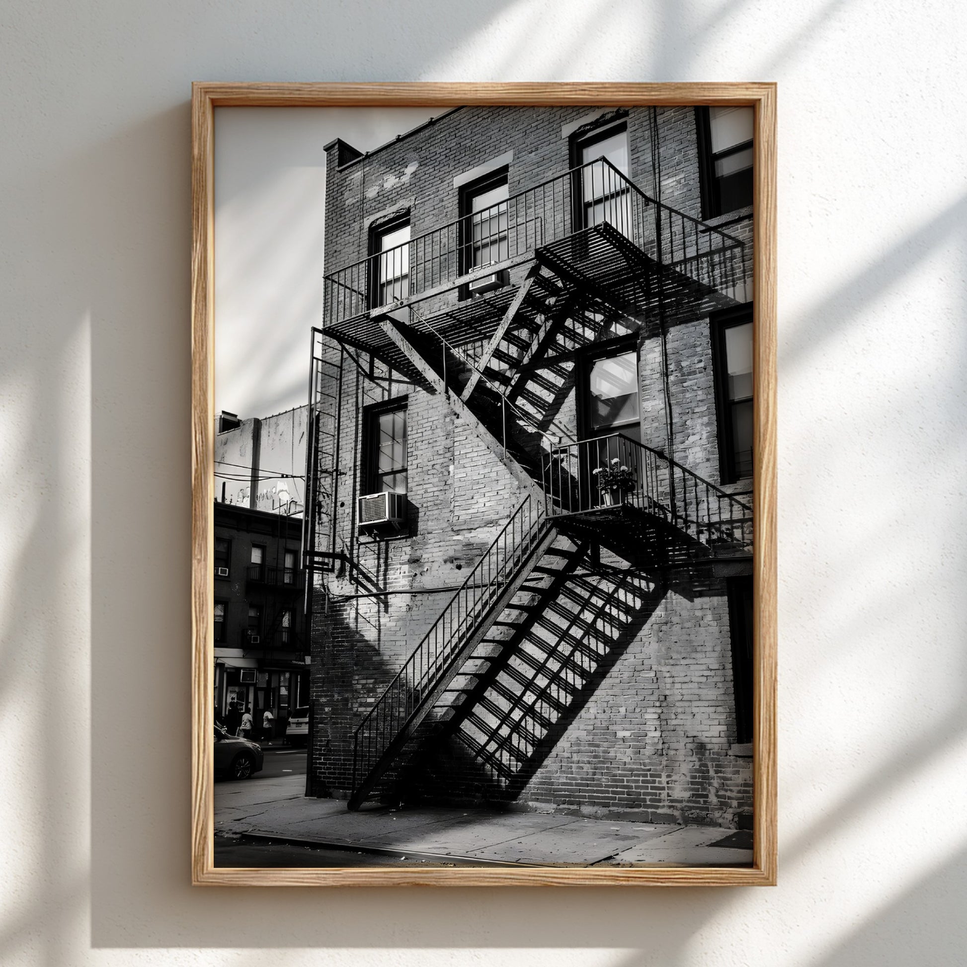 black and white wall decor showing fire escape stairs on brick building with shadows