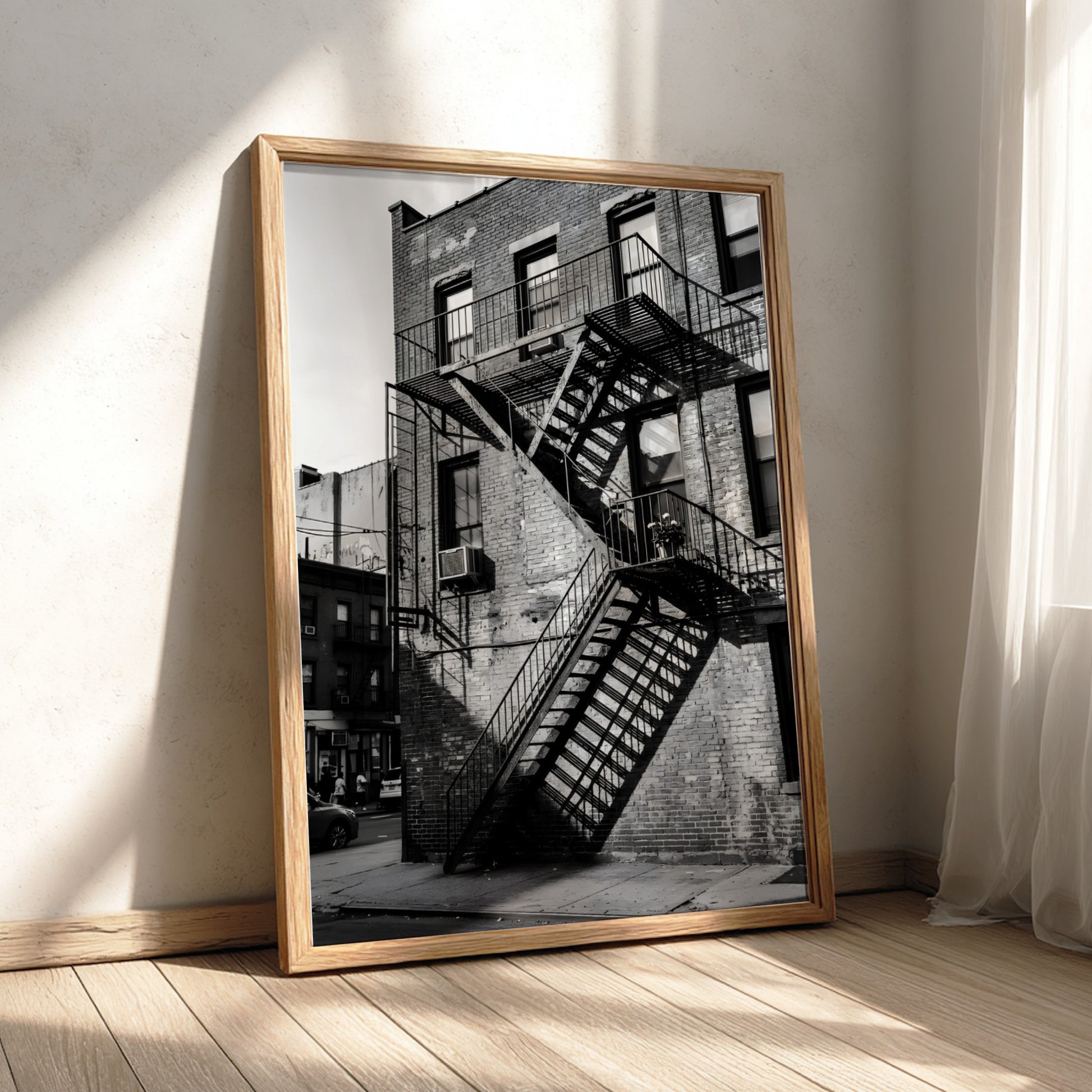 black and white wall decor showing fire escape stairs on brick building with shadows