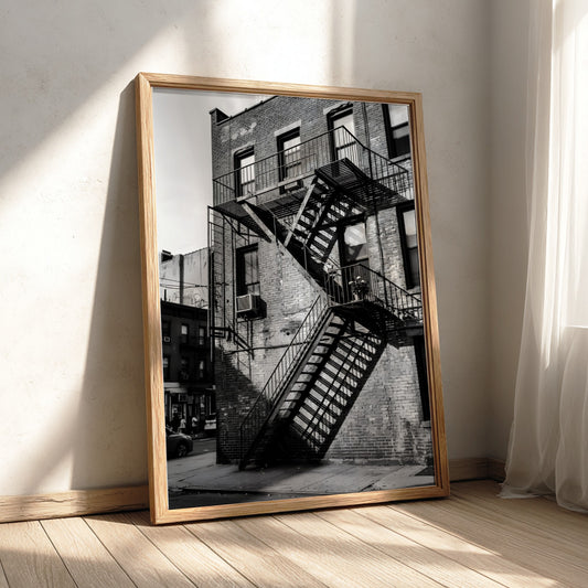 black and white wall decor showing fire escape stairs on brick building with shadows