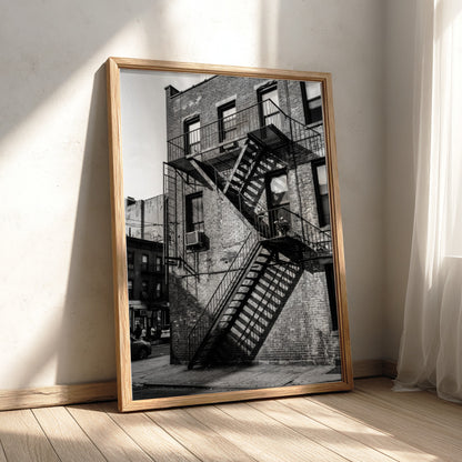 black and white wall decor showing fire escape on brick building with strong shadows