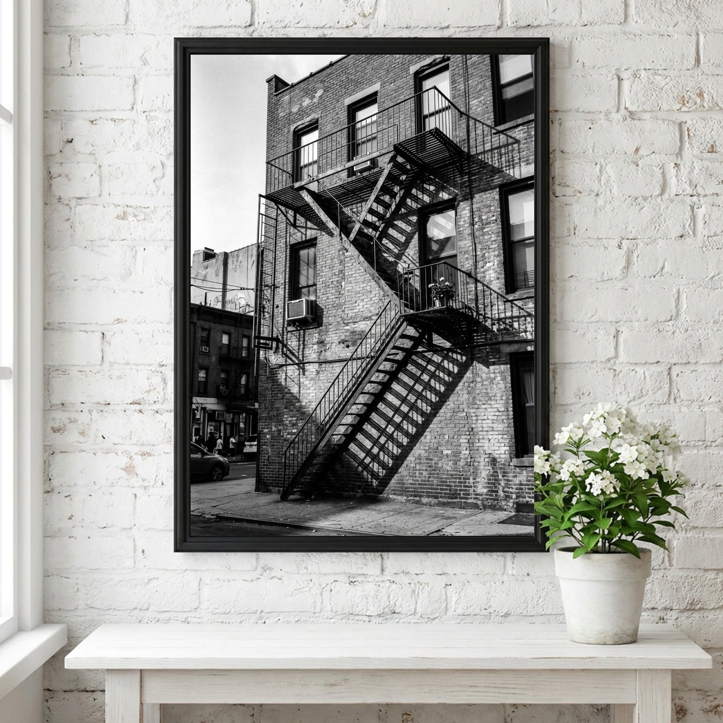 black and white wall decor showing fire escape on brick building with strong shadows