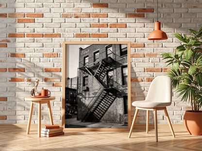 black and white wall decor showing fire escape on brick building with strong shadows