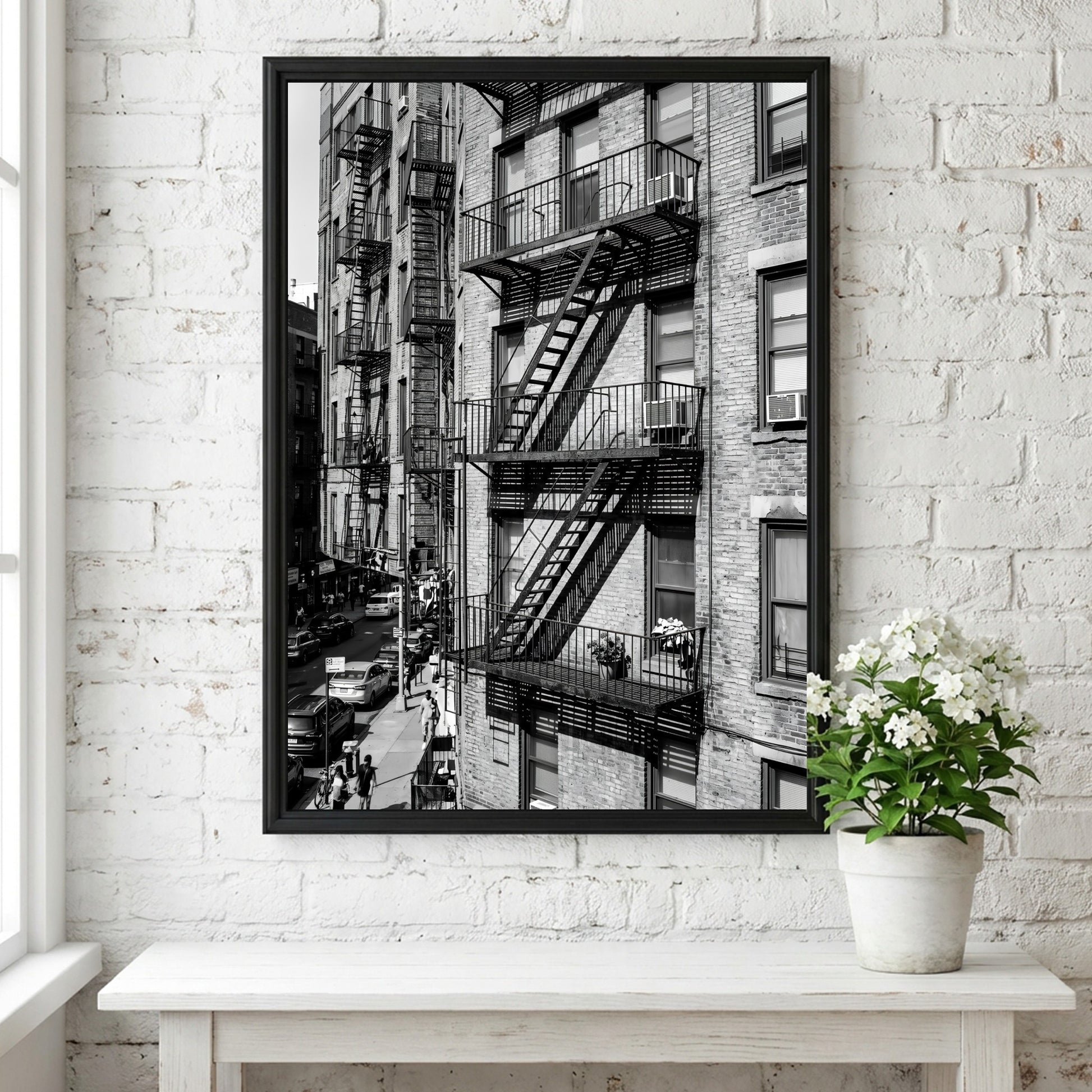 black and white wall decor featuring fire escape on brick tenement building with urban street below