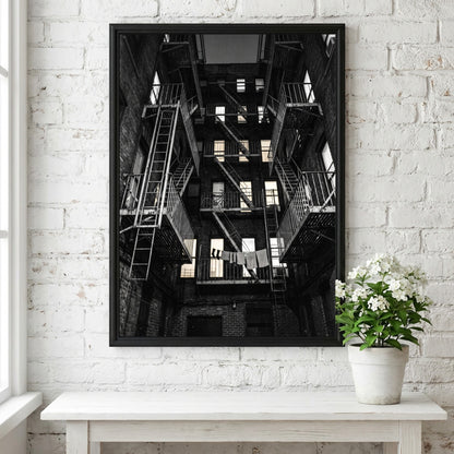 Black and white wall decor showing fire escapes on tenement building with geometric patterns and urban