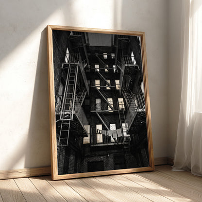 Black and white wall decor showing fire escapes on tenement building with geometric patterns and urban