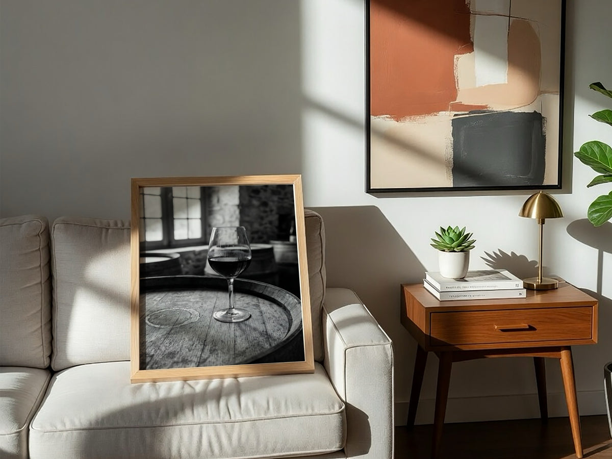 Black and white poster of a glass of wine on wooden barrel with window light shadows