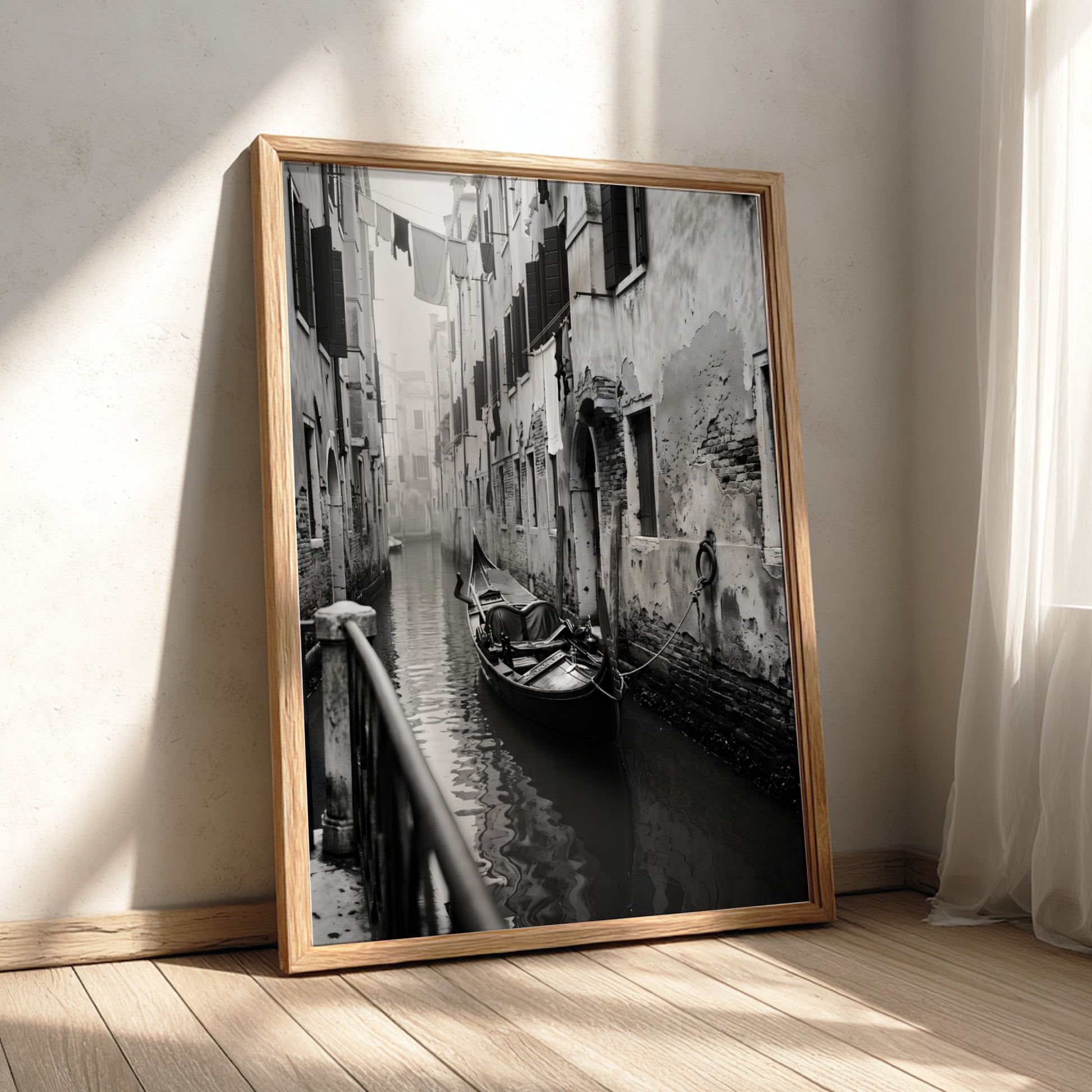 Black and white poster of a gondola moored in a narrow Venetian canal with historic buildings and hanging