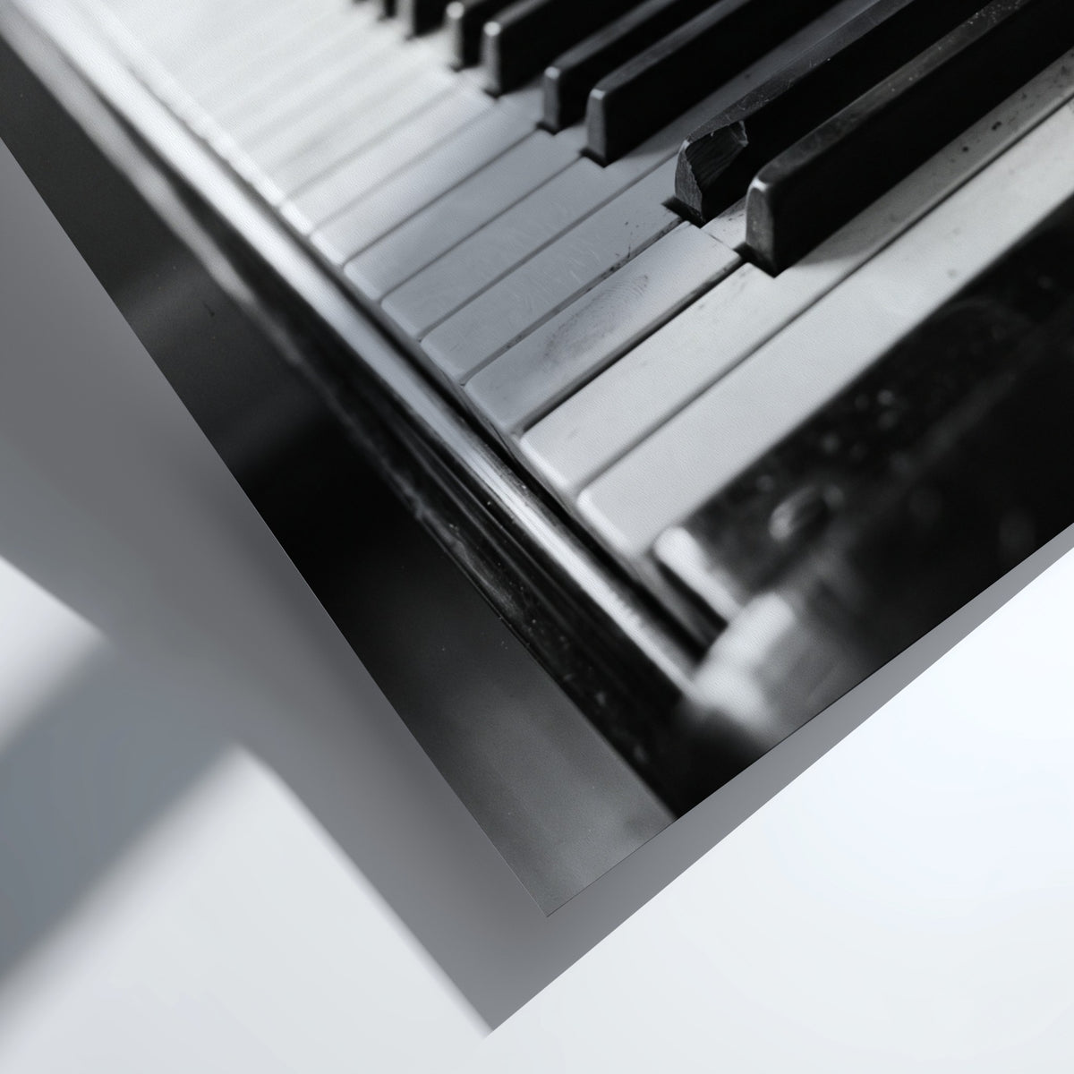 Wall decor showing close-up black and white grand piano keys with glossy finish and reflections