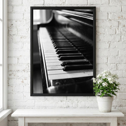 Wall decor showing close-up black and white grand piano keys with glossy finish and reflections
