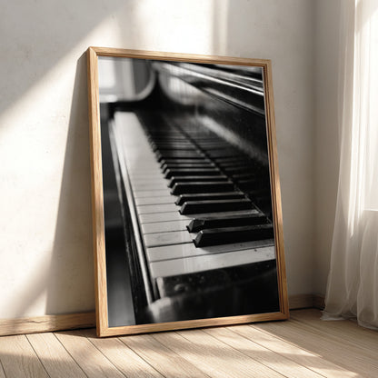 Wall decor showing close-up black and white grand piano keys with glossy finish and reflections