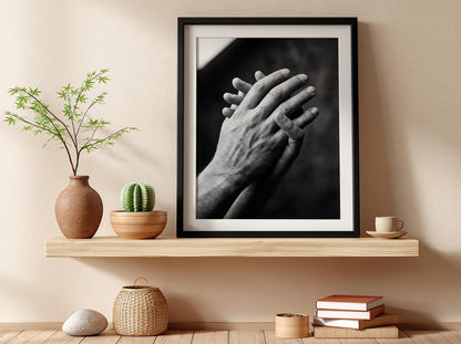 black and white poster featuring expressive hands in detailed monochrome style with textured skin and shadows