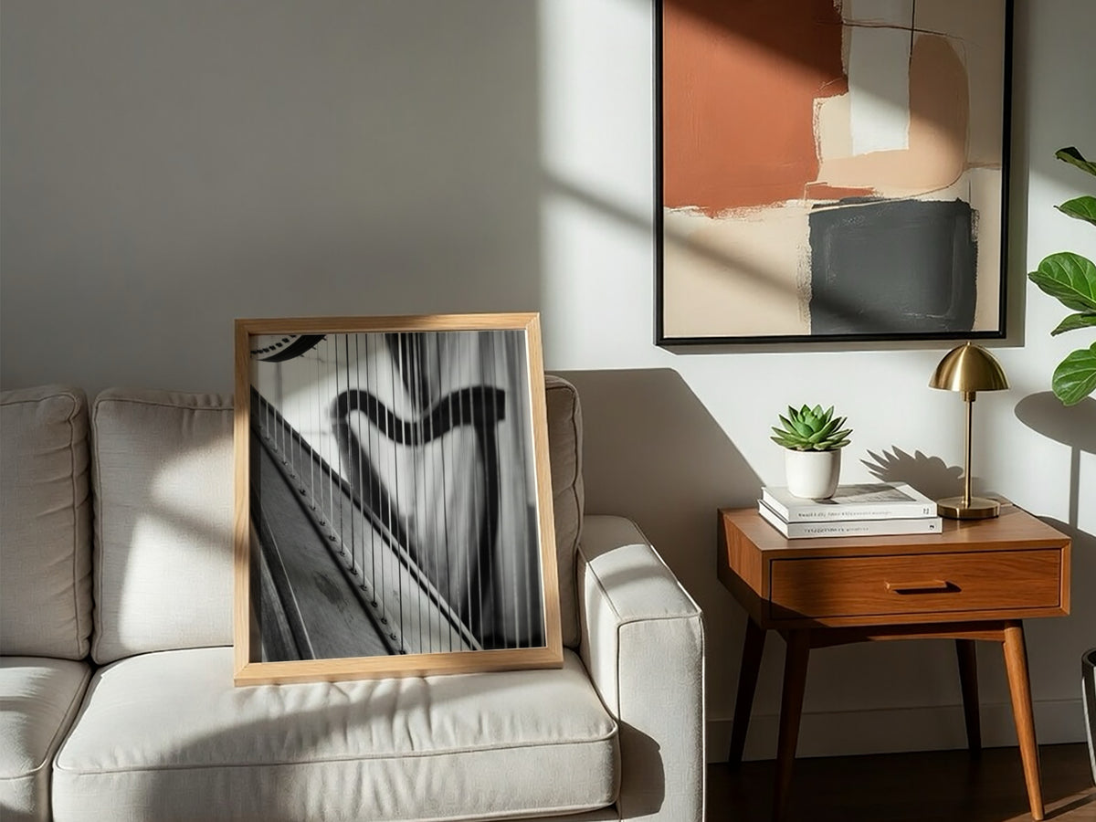 Black and white wall decor showing harp strings receding into soft focus with elegant curves and shadows