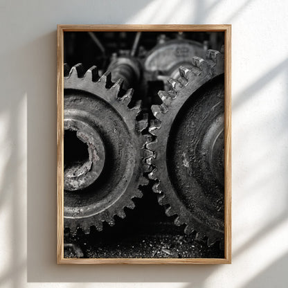 Poster of interlocking industrial gears in monochrome with detailed textured metal surfaces