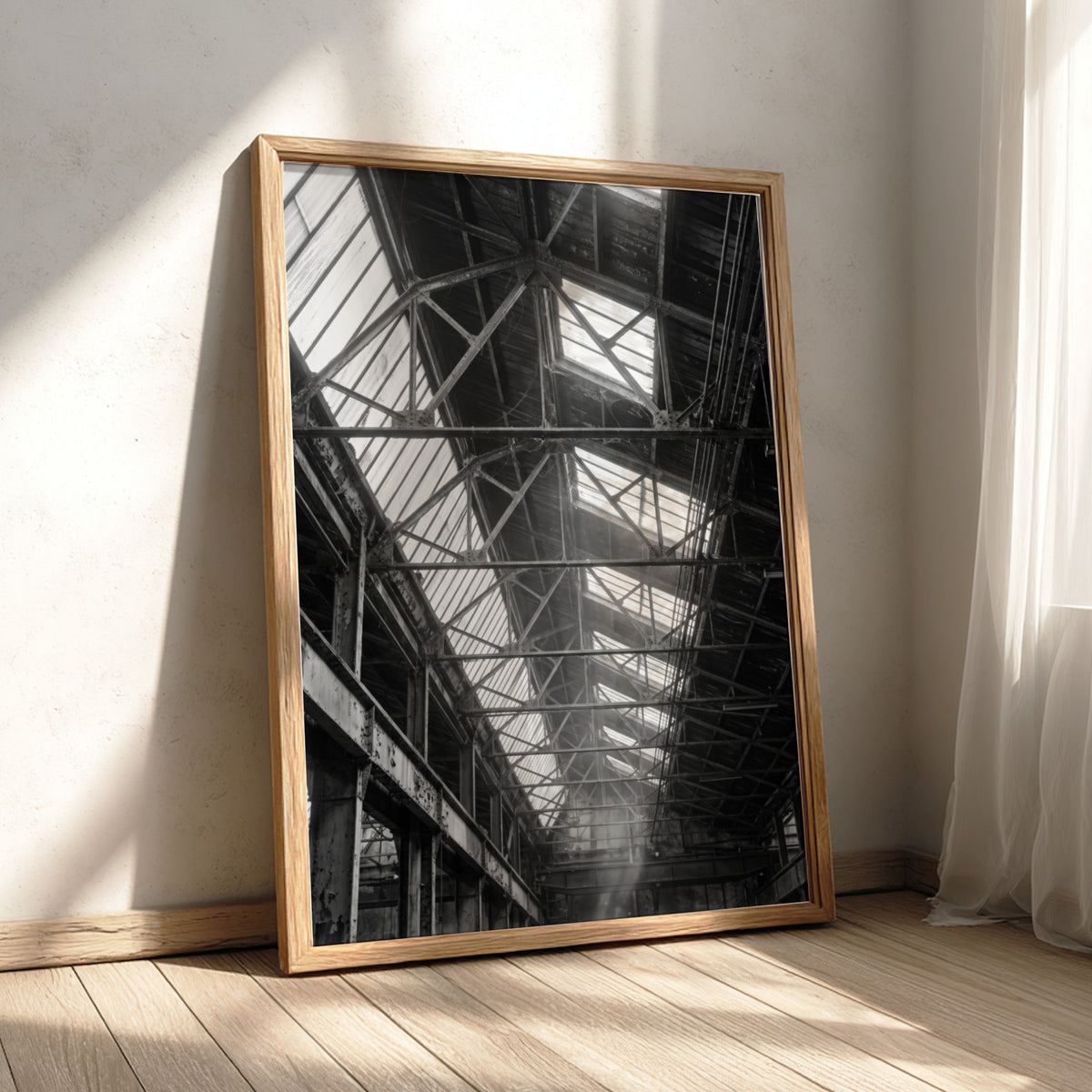 Industrial wall decor showing light streaming through factory roof beams in black and white