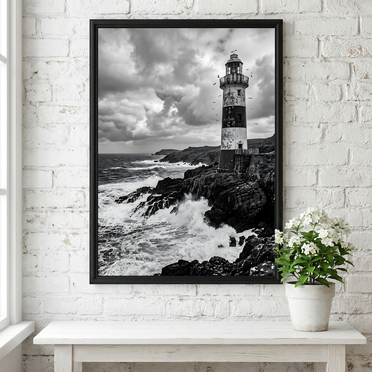 Black and white lighthouse poster with rocky coastline, crashing waves, and dramatic cloudy sky