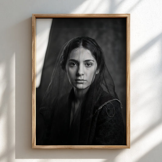 Black and white portrait wall decor of a model behind a sheer veil with soft shadows