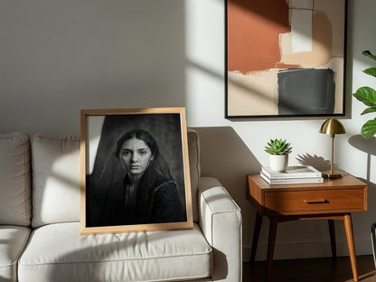 Black and white portrait wall decor of a model behind a sheer veil with soft shadows