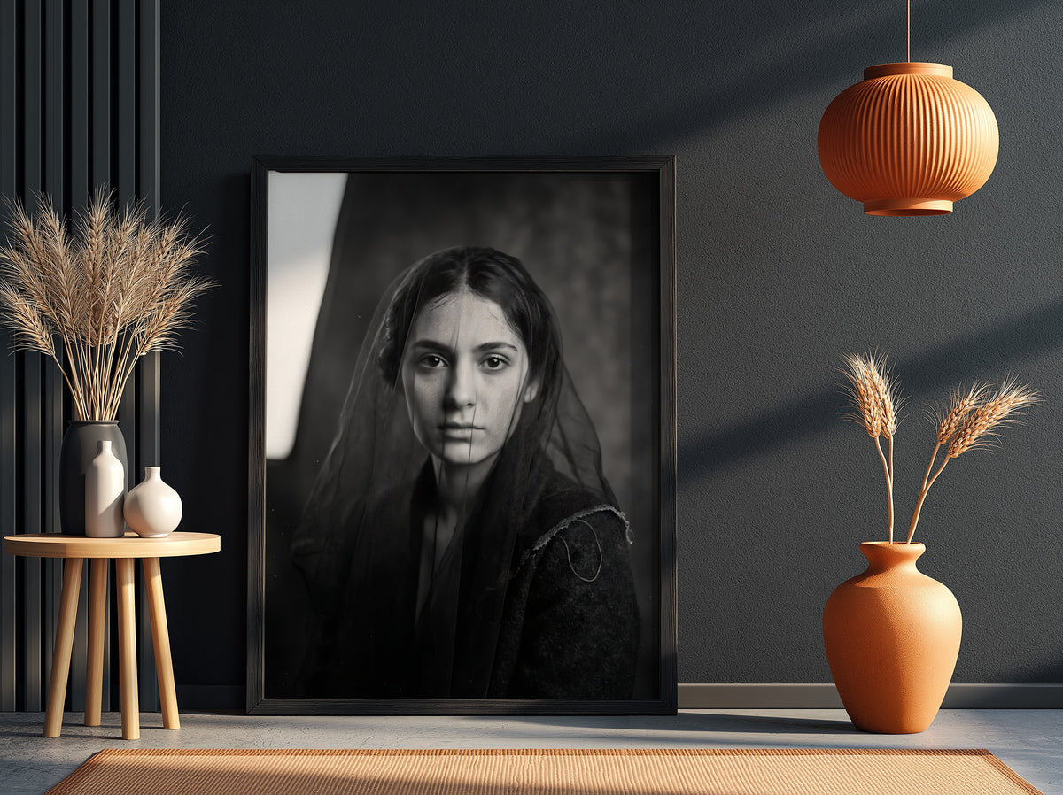 Black and white portrait wall decor of a model behind a sheer veil with soft shadows