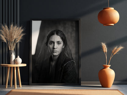 Black and white portrait wall decor of a model behind a sheer veil with soft shadows