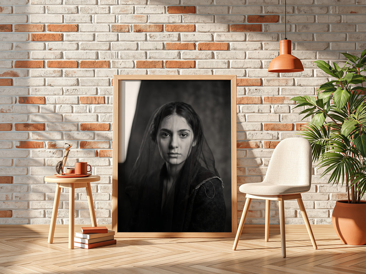 Black and white portrait wall decor of a model behind a sheer veil with soft shadows