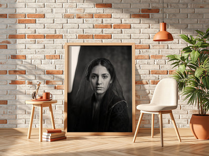 Black and white portrait wall decor of a model behind a sheer veil with soft shadows