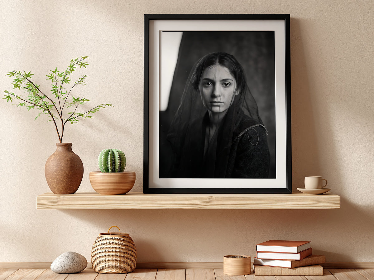 Black and white portrait wall decor of a model behind a sheer veil with soft shadows