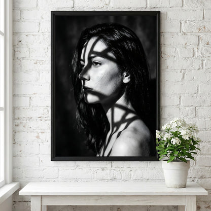 Black and white portrait wall decor of model lit by patterned gobo casting shadows