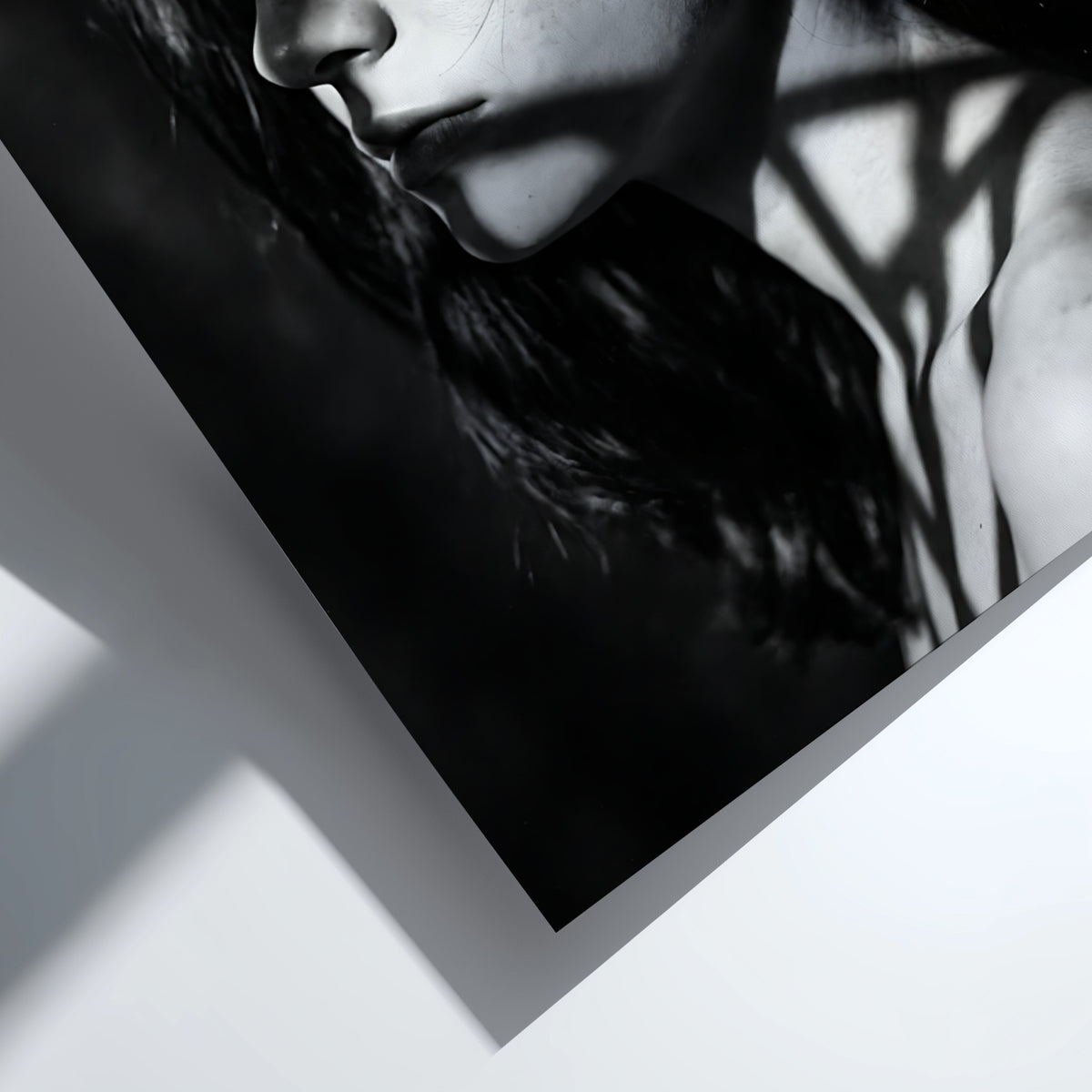 Black and white portrait wall decor of model lit by patterned gobo casting shadows