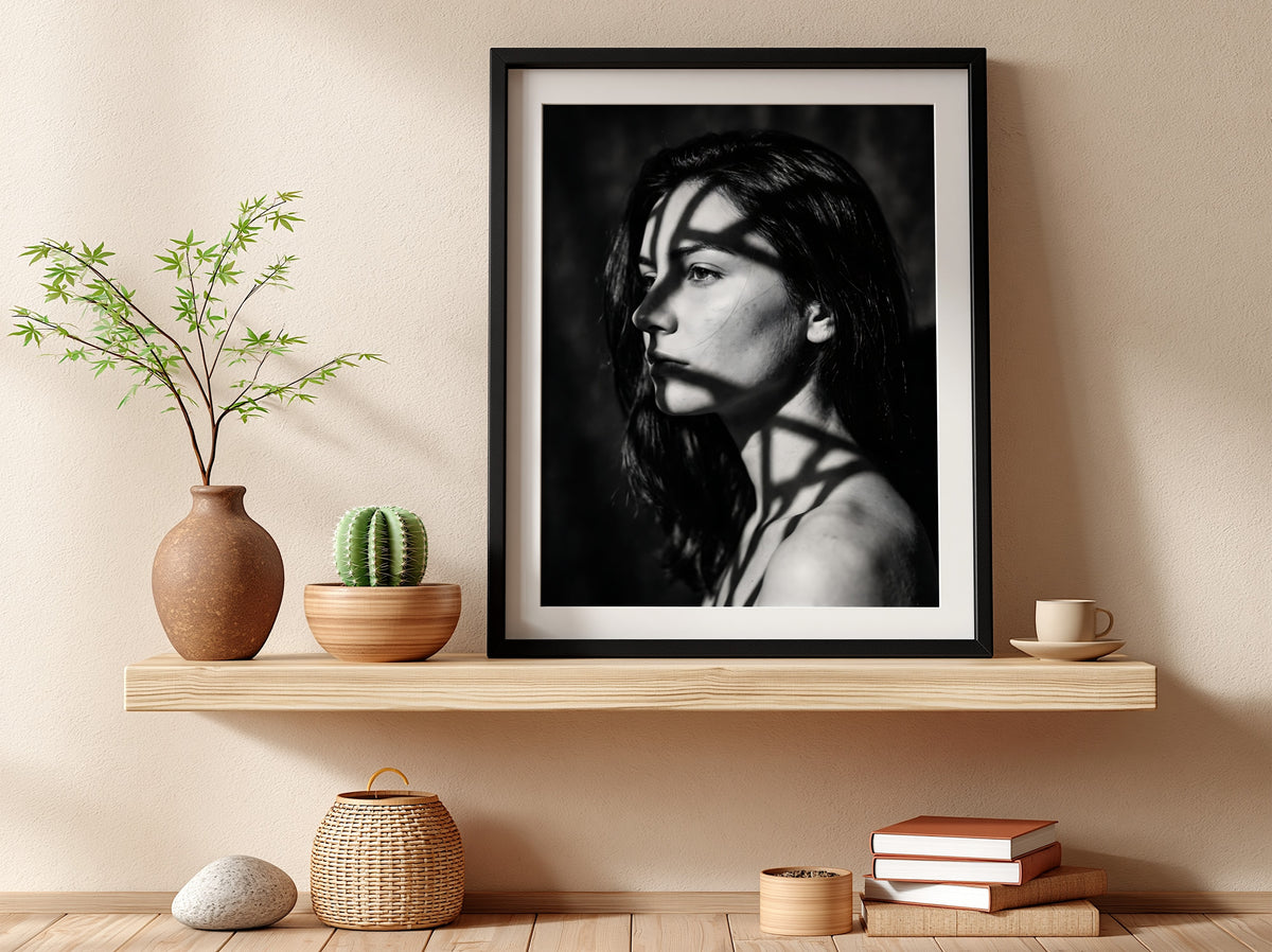 Black and white portrait wall decor of model lit by patterned gobo casting shadows
