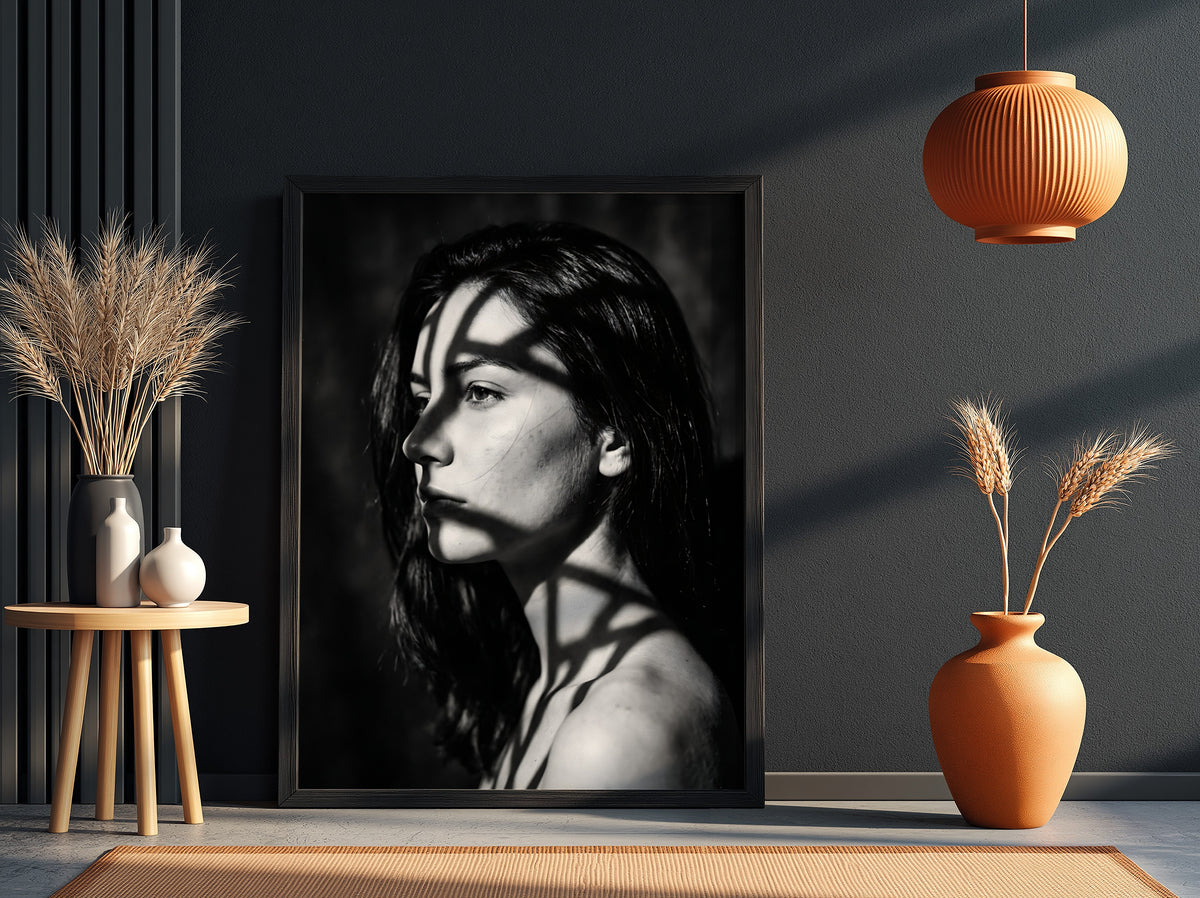 Black and white portrait wall decor of model lit by patterned gobo casting shadows