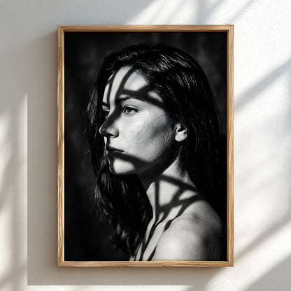 Black and white portrait wall decor of model lit by patterned gobo casting shadows