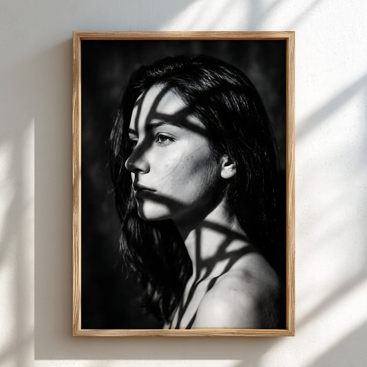 Black and white portrait wall decor of model lit by patterned gobo casting shadows