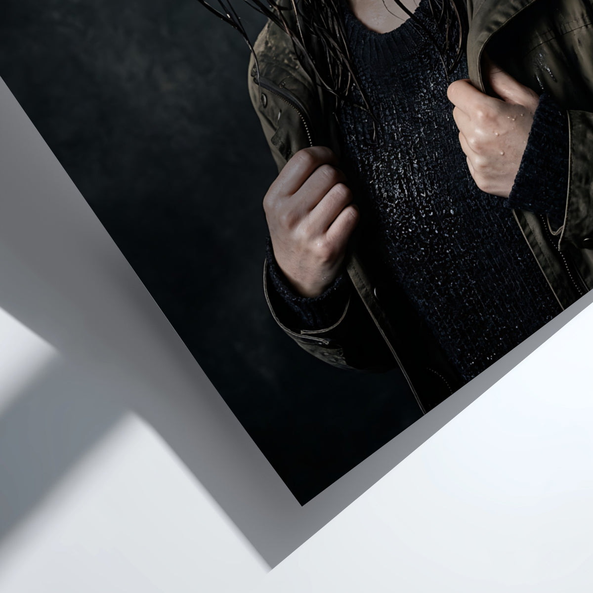 Framed poster showing model with rain-soaked hair in dark moody tones and contemplative pose