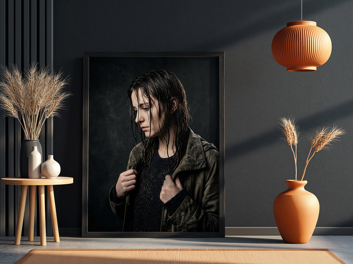 Framed poster showing model with rain-soaked hair in dark moody tones and contemplative pose
