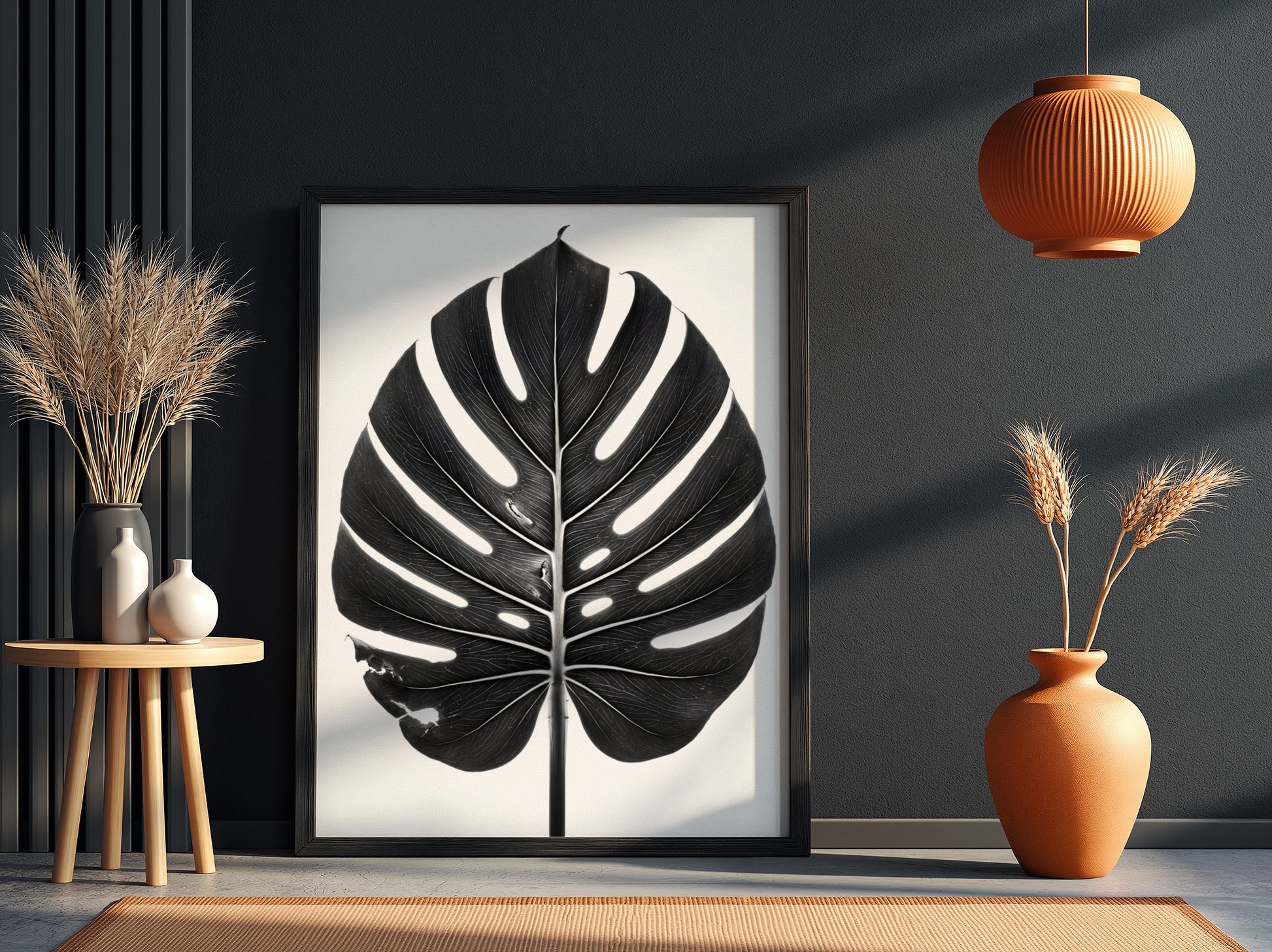 Wall decor featuring a black Monstera leaf with backlit studio effect and natural wood frame on white