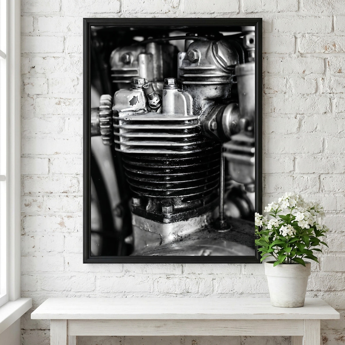 Wall decor featuring black and white close-up photo of motorcycle engine cylinder with metal textures